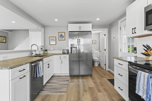 175 Beach Ave Unit 2, Kennebunk, ME 04043 - kitchen with a peninsula, a sink, recessed lighting, wood finished floors, and appliances with stainless steel finishes