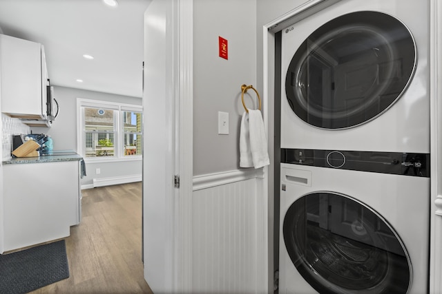 175 Beach Ave Unit 2, Kennebunk, ME 04043 - laundry room featuring recessed lighting, laundry area, wood finished floors, stacked washing maching and dryer, and wainscoting