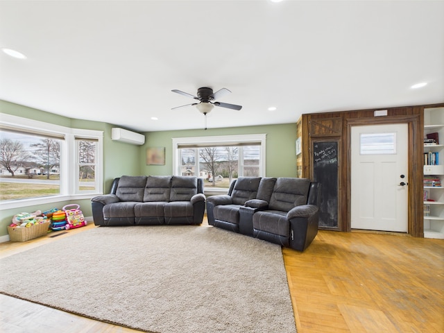 living room featuring recessed lighting, a ceiling fan, light wood-style floors, and a wall mounted AC