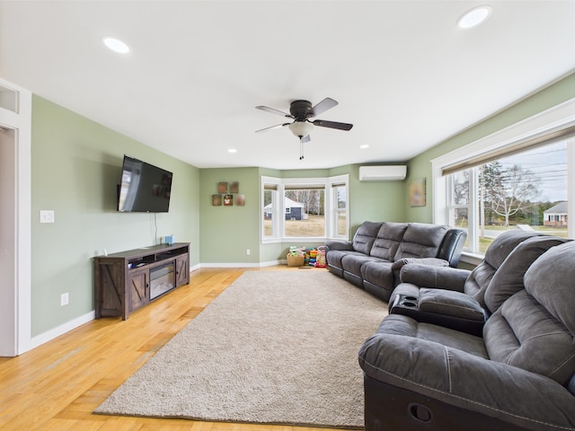 living room with recessed lighting, ceiling fan, and a wall mounted AC