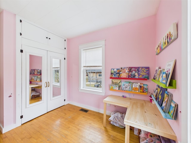 game room featuring baseboards, visible vents, and light wood finished floors