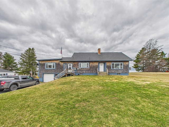 single story home with a chimney, a front yard, and a garage