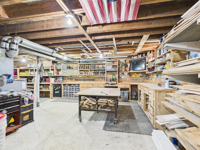 unfinished below grade area featuring a workshop area