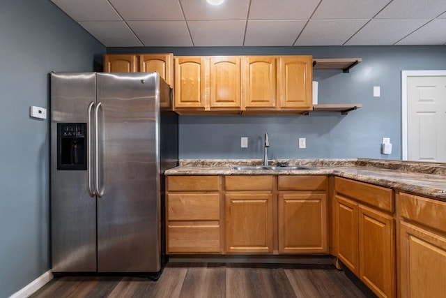 kitchen featuring dark wood-style floors, open shelves, a sink, a paneled ceiling, and stainless steel refrigerator with ice dispenser