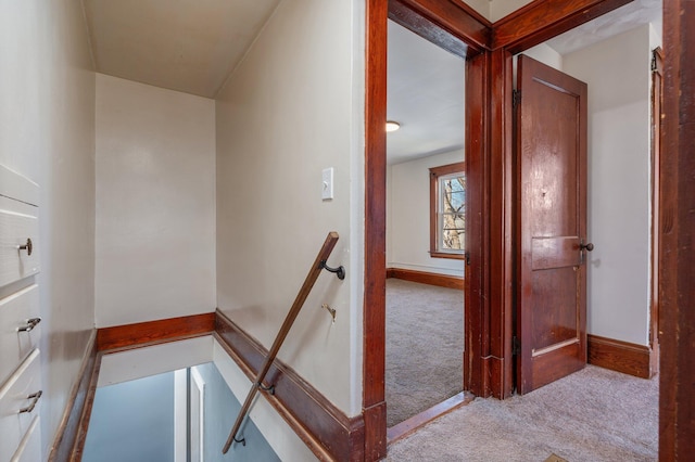 stairs with baseboards and carpet flooring