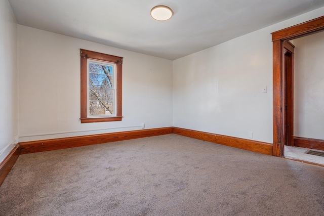 carpeted spare room with baseboards