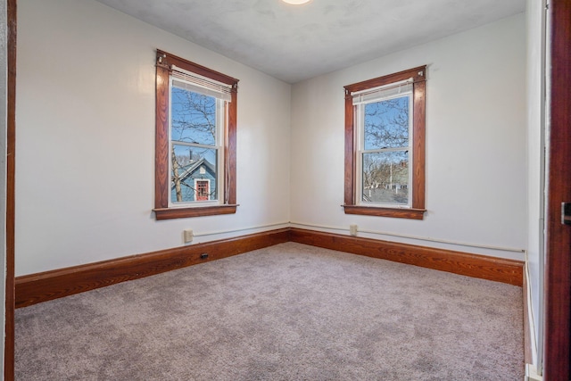 empty room with baseboards and carpet floors