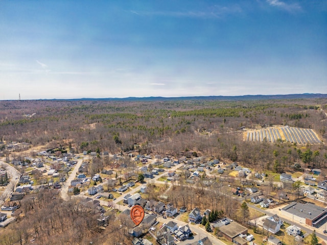 aerial view featuring a forest view and a residential view