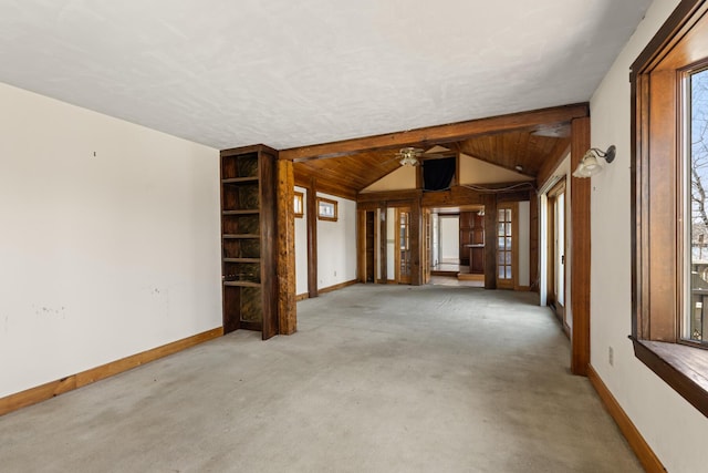 interior space featuring vaulted ceiling, carpet, a ceiling fan, and baseboards