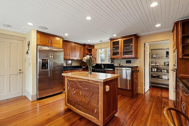 kitchen with dark wood-style floors, open shelves, stainless steel appliances, and a kitchen island