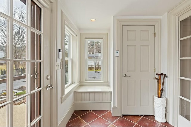entryway featuring dark tile patterned floors