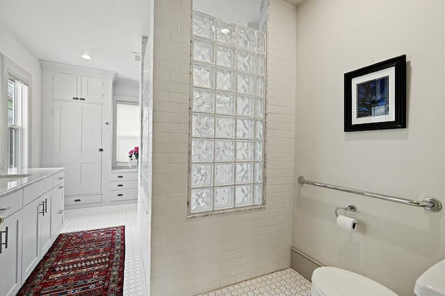 full bathroom with toilet, recessed lighting, a walk in shower, vanity, and tile patterned flooring