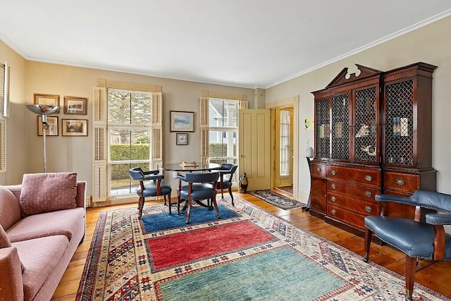 interior space featuring ornamental molding and light wood-style flooring