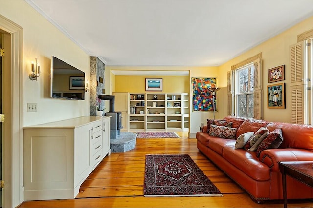 living room featuring light wood finished floors and a wood stove