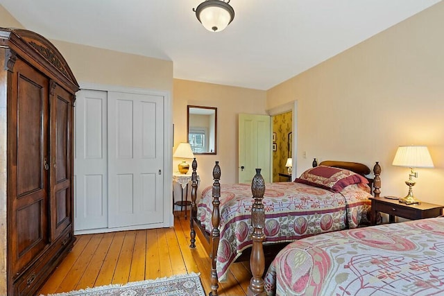 bedroom with light wood-type flooring and a closet