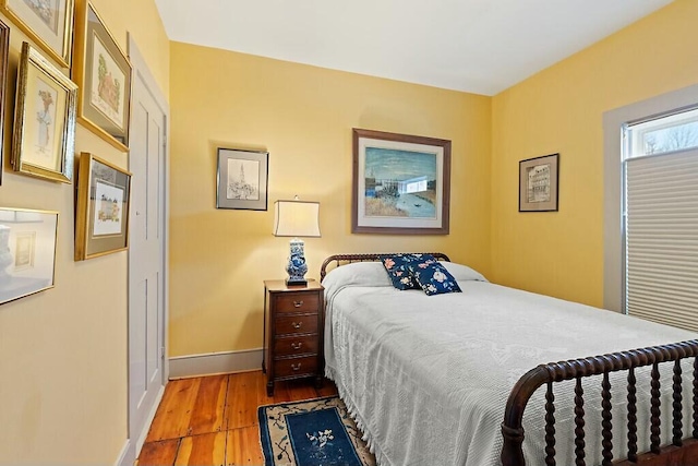 bedroom featuring wood finished floors and baseboards