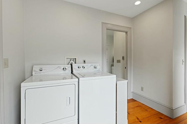 laundry room with light wood finished floors, separate washer and dryer, recessed lighting, and laundry area