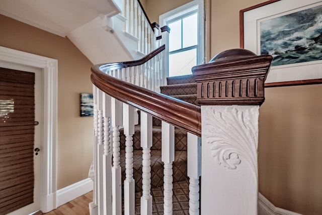 stairs with baseboards and wood finished floors
