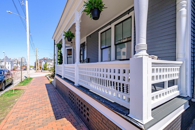 view of property exterior with a porch and a residential view
