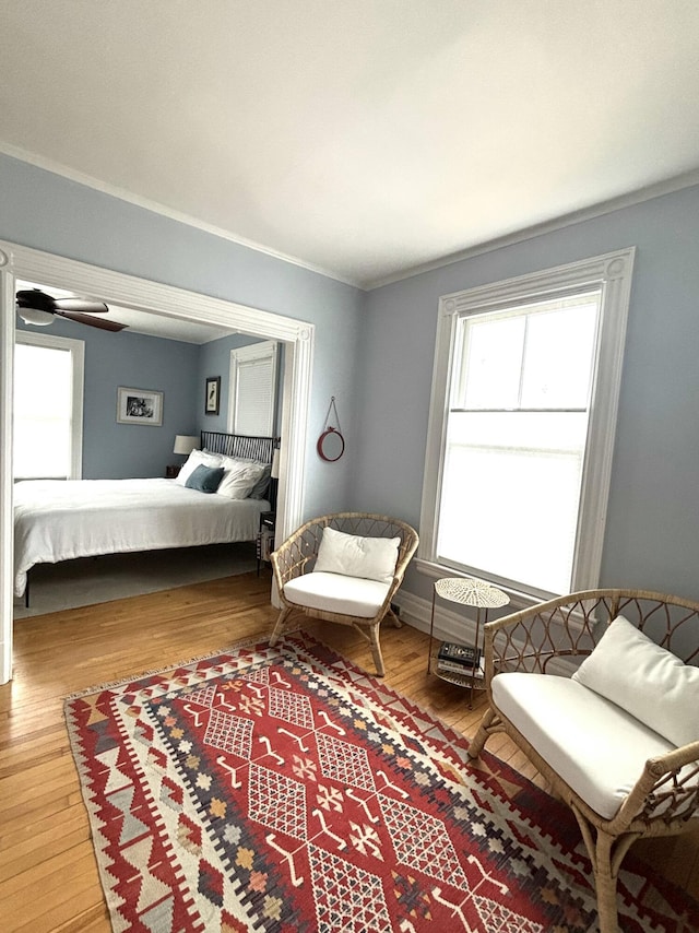 bedroom featuring crown molding and wood finished floors