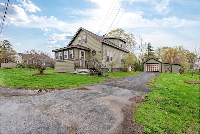 30 Munroe St, Bangor, ME 04401 - view of front of house with asphalt driveway, a detached garage, an outdoor structure, and a front yard
