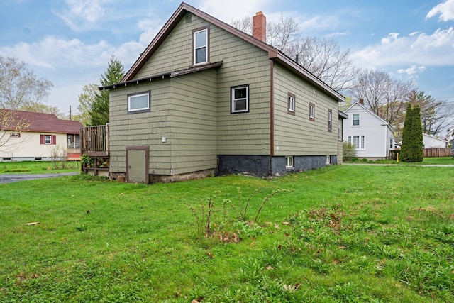 30 Munroe St, Bangor, ME 04401 - view of home's exterior featuring a chimney, a lawn, and a deck