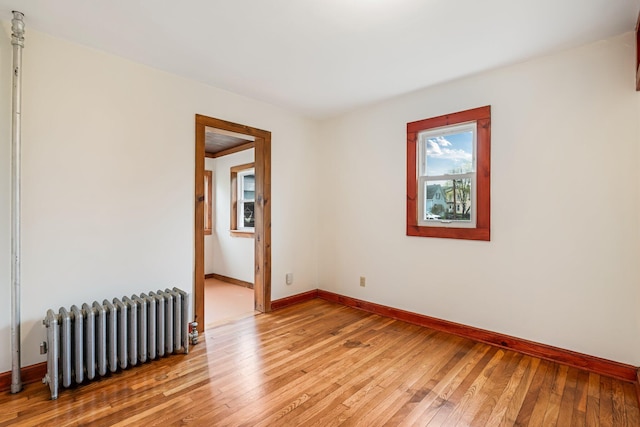 30 Munroe St, Bangor, ME 04401 - spare room featuring radiator heating unit, light wood-style floors, and baseboards