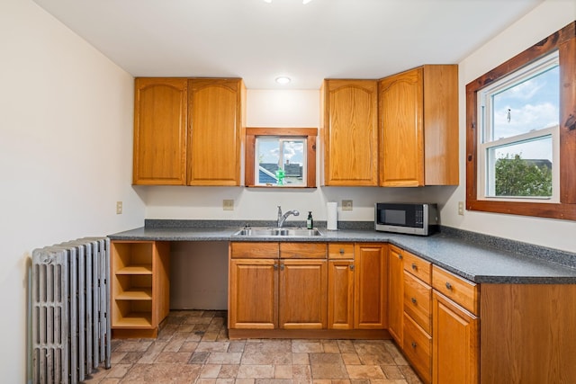 30 Munroe St, Bangor, ME 04401 - kitchen featuring radiator heating unit, stainless steel microwave, a sink, dark countertops, and recessed lighting