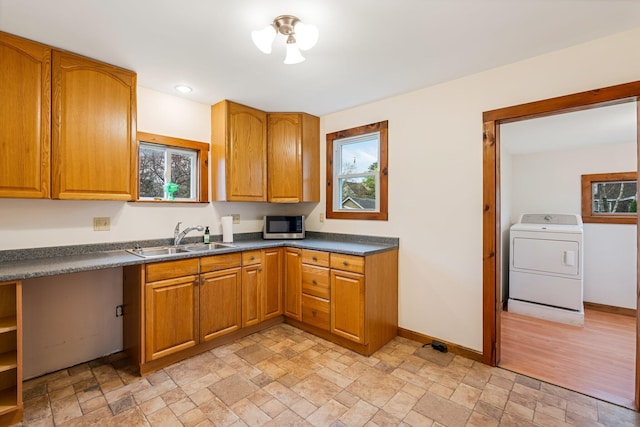 30 Munroe St, Bangor, ME 04401 - kitchen featuring washer / dryer, a sink, stainless steel microwave, and light stone finish floors
