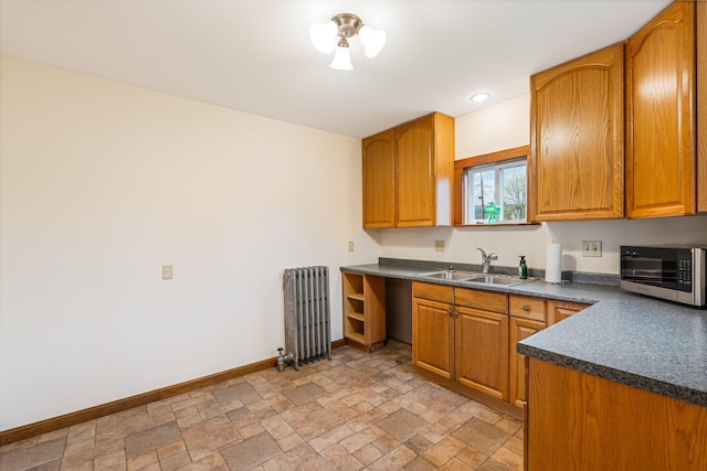 30 Munroe St, Bangor, ME 04401 - kitchen featuring radiator heating unit, a sink, dark countertops, baseboards, and stainless steel microwave