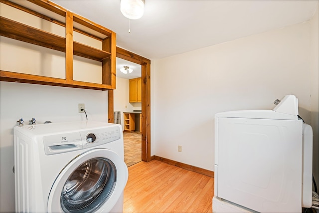 30 Munroe St, Bangor, ME 04401 - washroom with light wood-style flooring, washing machine and dryer, radiator, and baseboards