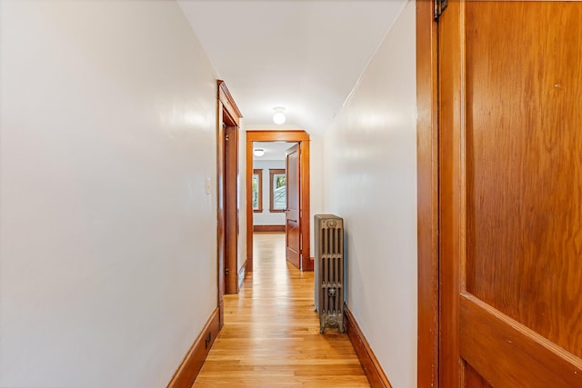 30 Munroe St, Bangor, ME 04401 - hallway with radiator heating unit, light wood-style flooring, and baseboards