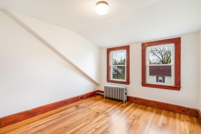 30 Munroe St, Bangor, ME 04401 - additional living space with radiator, light wood finished floors, vaulted ceiling, and baseboards
