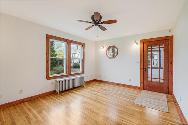 30 Munroe St, Bangor, ME 04401 - empty room with radiator, plenty of natural light, light wood-style floors, and baseboards