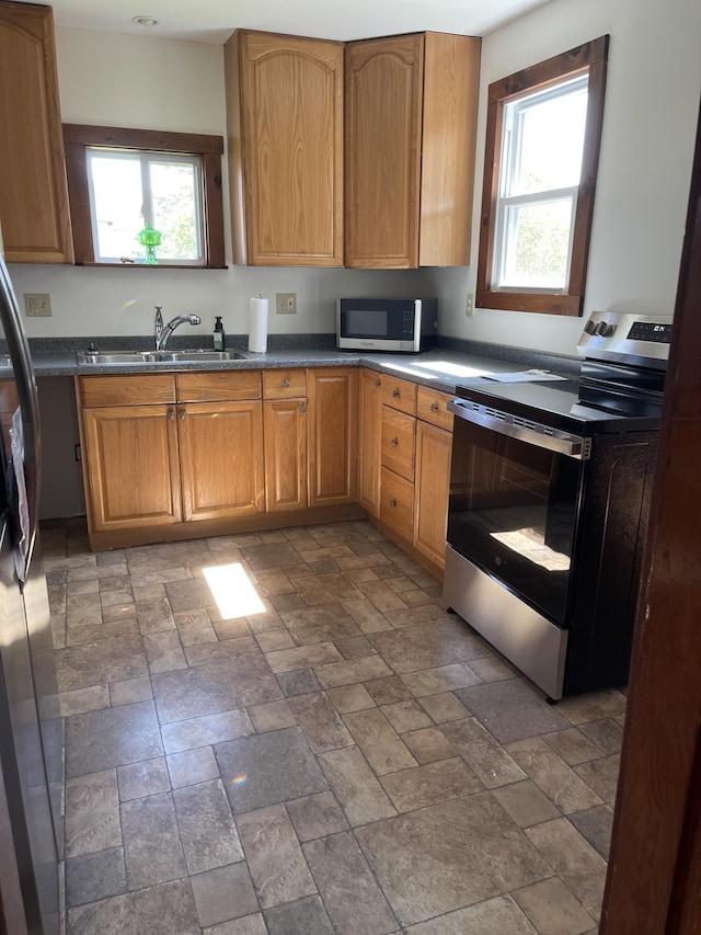 30 Munroe St, Bangor, ME 04401 - kitchen featuring appliances with stainless steel finishes, a sink, healthy amount of natural light, and stone finish floors