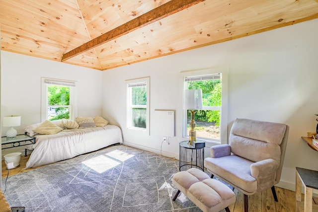 bedroom featuring baseboards, wood finished floors, vaulted ceiling with beams, and wood ceiling