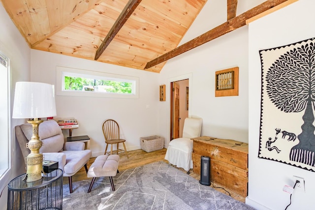 sitting room with wooden ceiling, baseboards, wood finished floors, and lofted ceiling with beams
