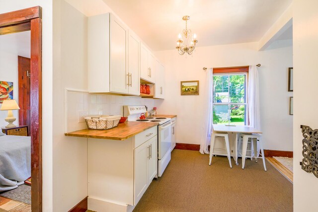 kitchen featuring white electric stove, an inviting chandelier, butcher block counters, baseboards, and white cabinetry