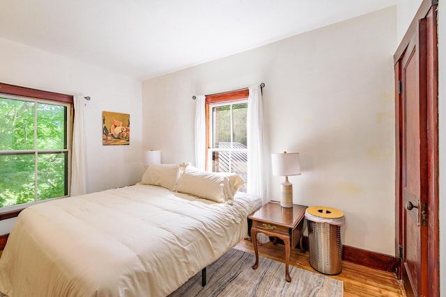 bedroom featuring baseboards and wood finished floors