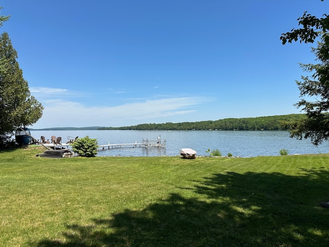 dock area featuring a yard and a water view