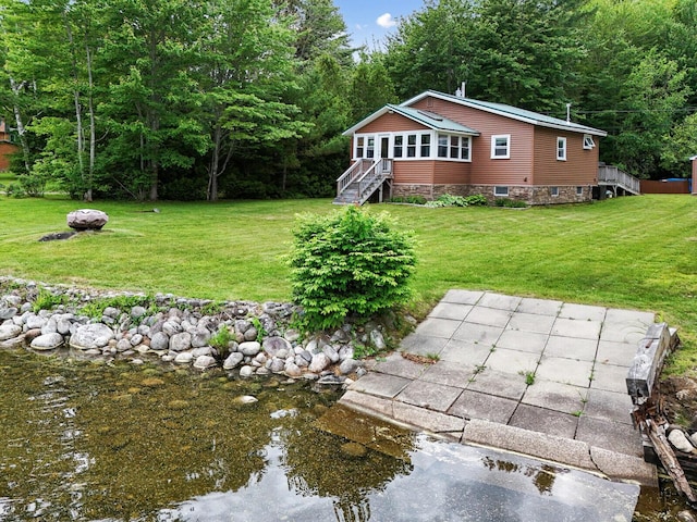view of yard with an outdoor fire pit and a view of trees