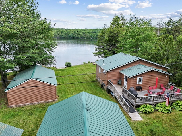 aerial view with a water view and a forest view