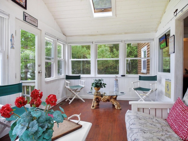 sunroom featuring wood finished floors, vaulted ceiling with skylight, and wood ceiling