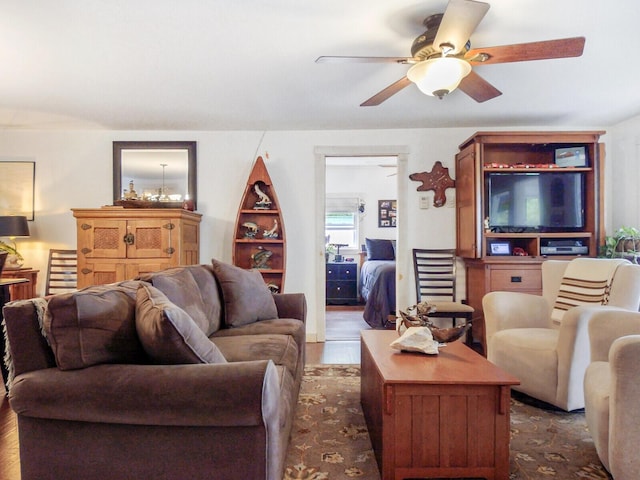 living area with wood finished floors and a ceiling fan