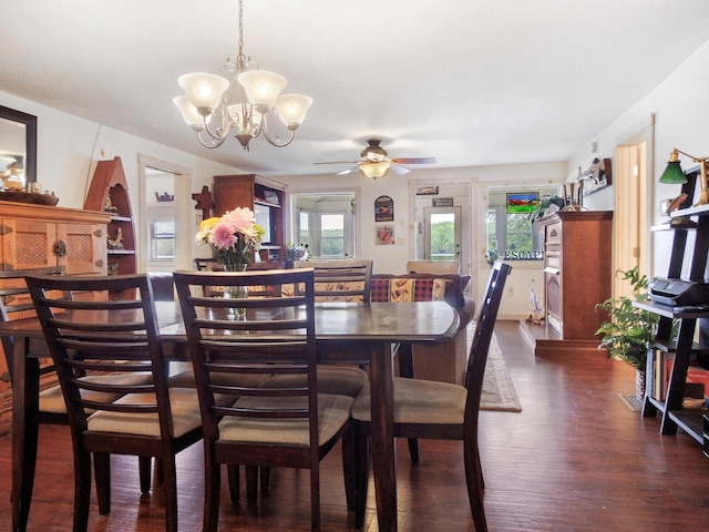 dining space featuring dark wood-style flooring and ceiling fan with notable chandelier