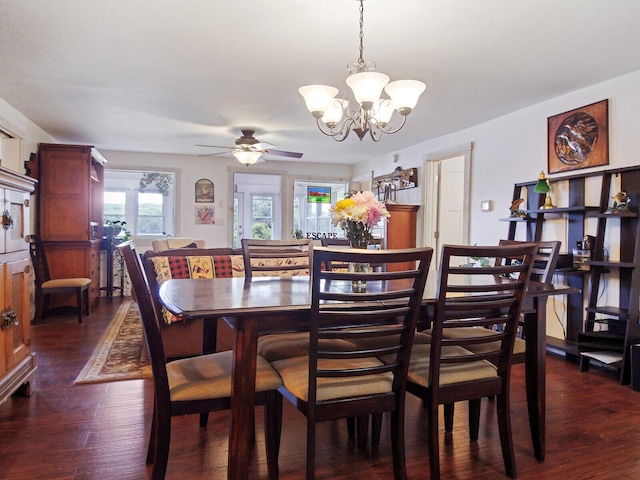 dining room with dark wood-style flooring and ceiling fan with notable chandelier