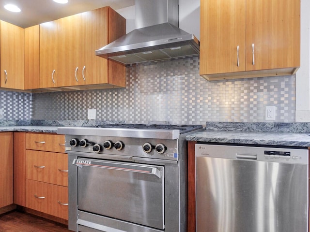 kitchen with tasteful backsplash, stainless steel appliances, dark wood-style flooring, and wall chimney range hood