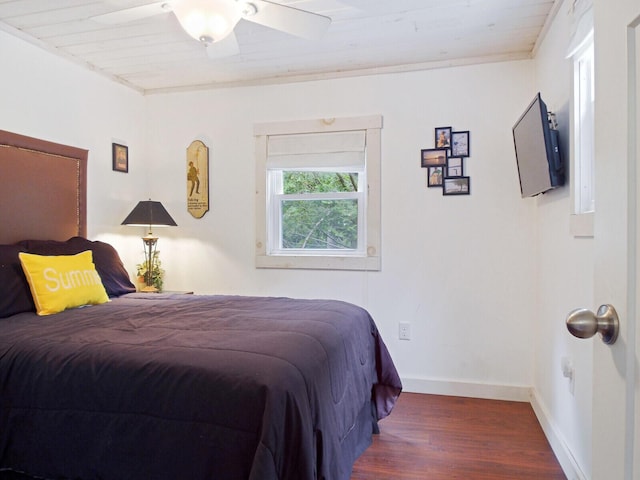 bedroom with wood finished floors and baseboards