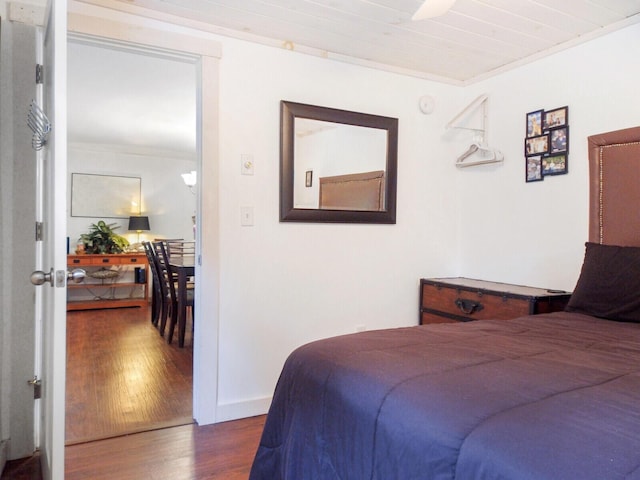 bedroom with baseboards and wood finished floors