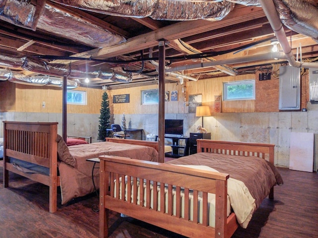 bedroom featuring electric panel and wood finished floors